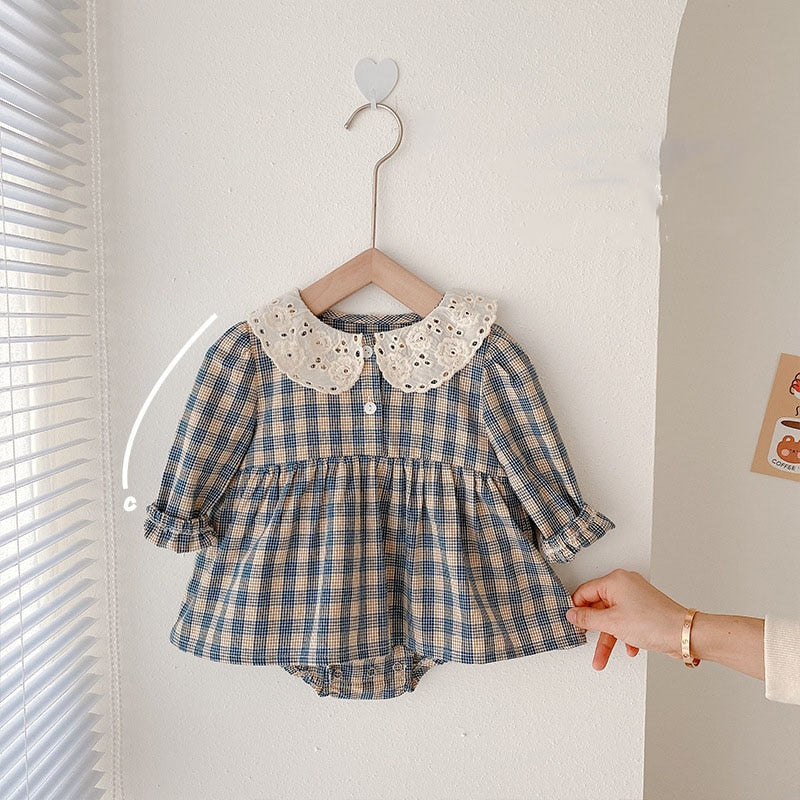 Blue plaid dress bodysuit on a hanger
