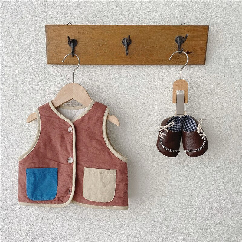 Brown fleece vest with blue and cream pockets