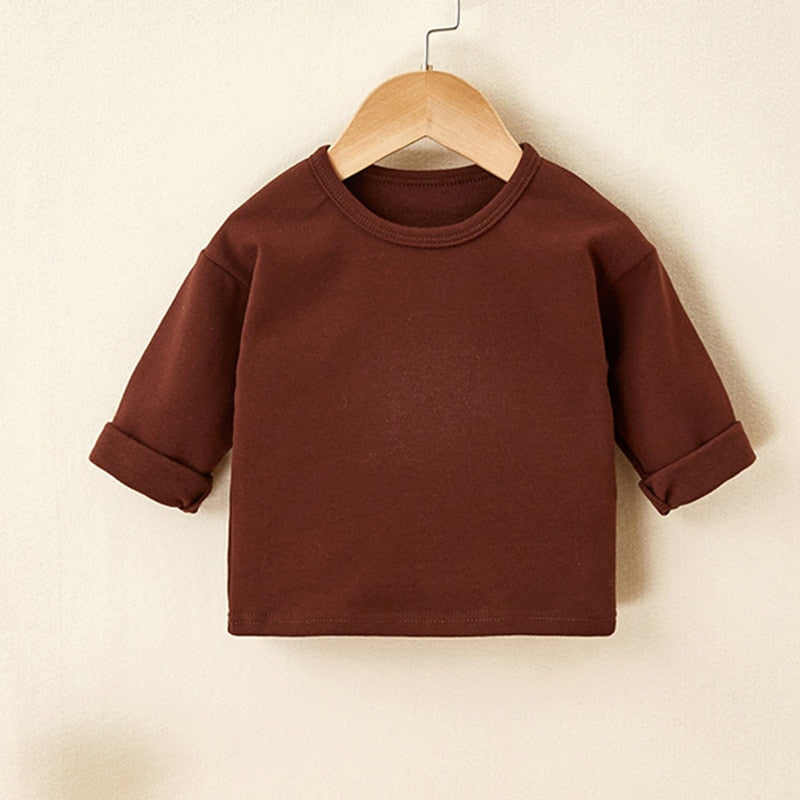 Brown long sleeve baby top on a hanger