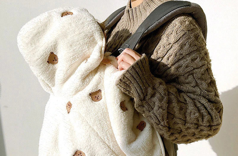 Close-up of plush cape being carried