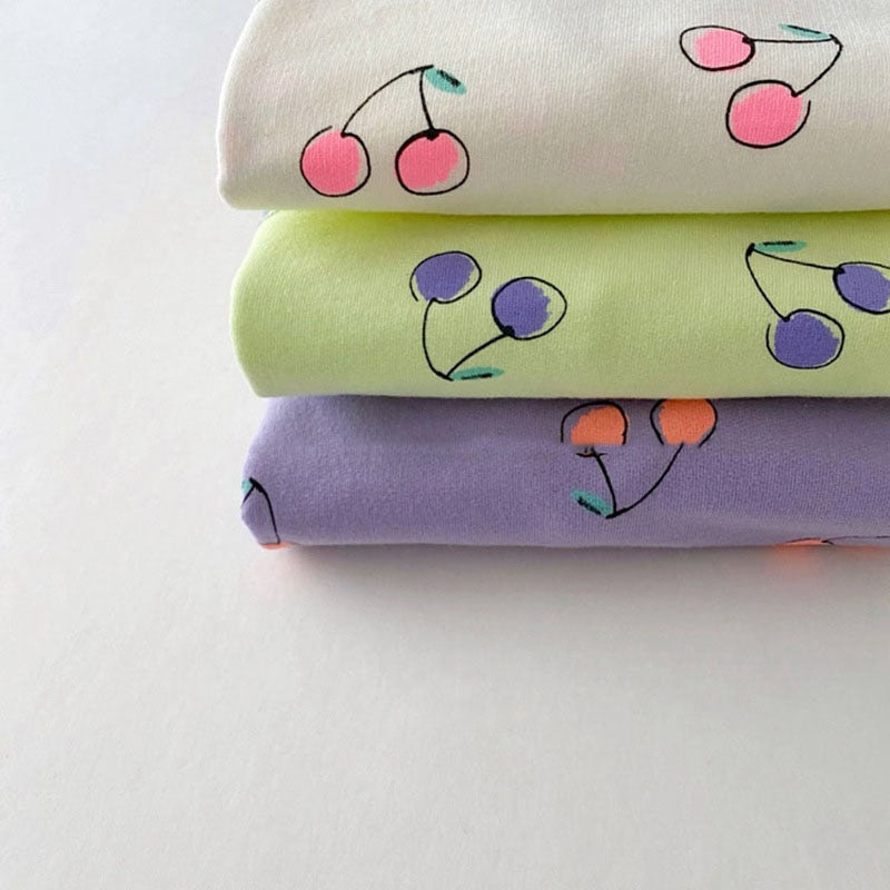 Stacked cherry print tops in three colours