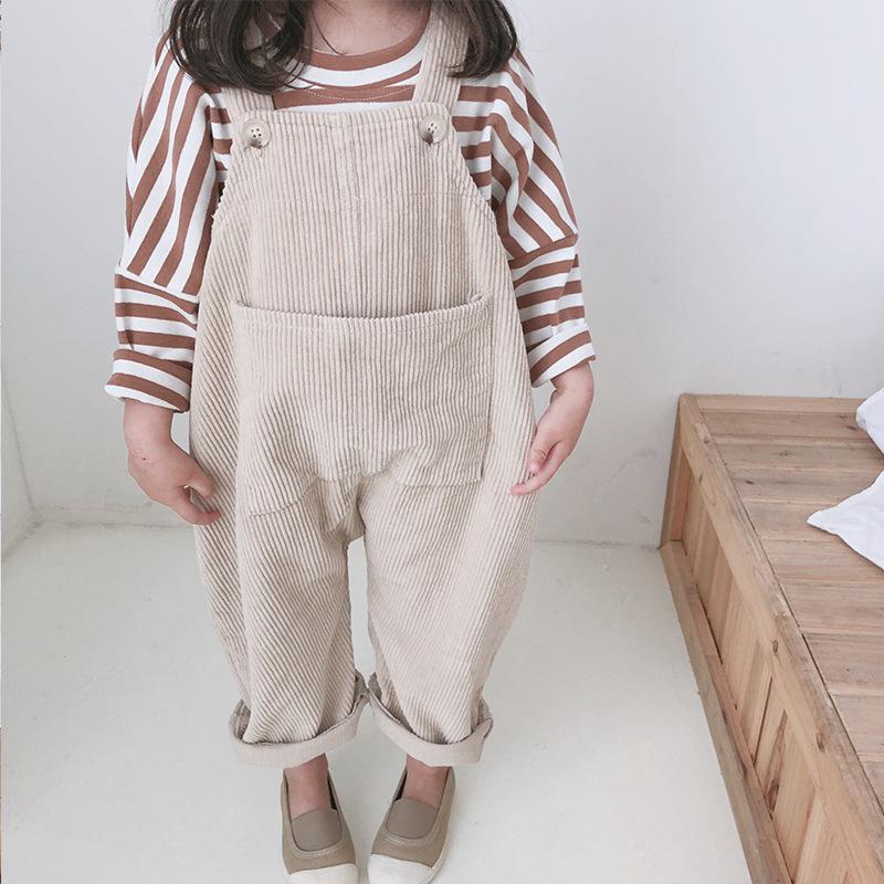 Close-up of beige corduroy overalls on child
