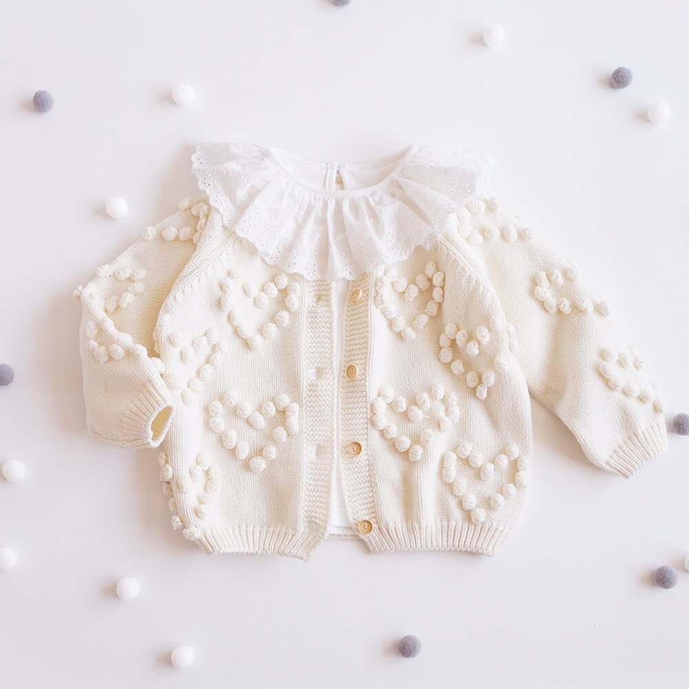 Cream bobble heart knit cardigan with pom-poms