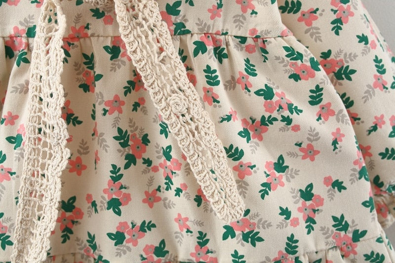 Close-up of crochet shawl tie on floral dress