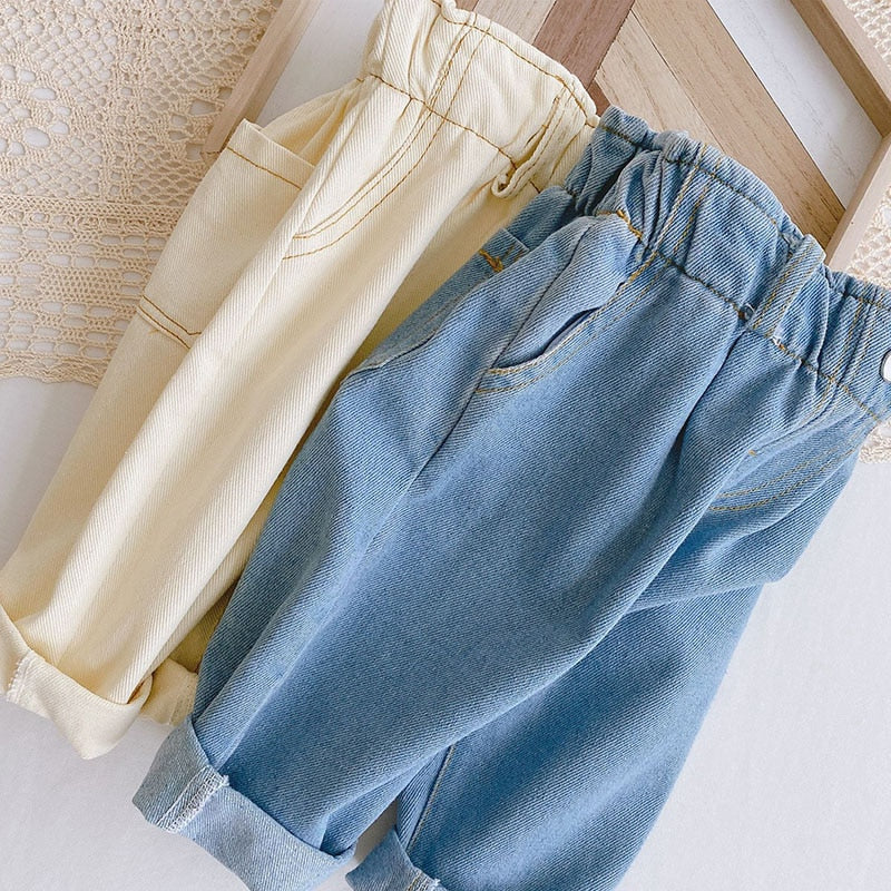 Beige and blue denim pants on a basket