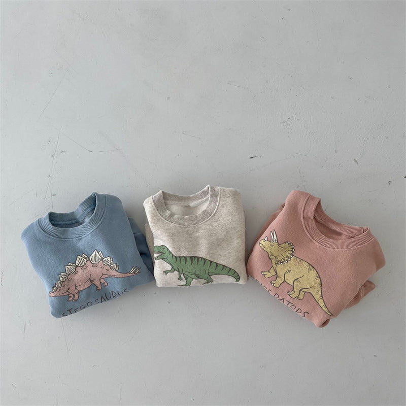 Three dinosaur pullovers laid flat