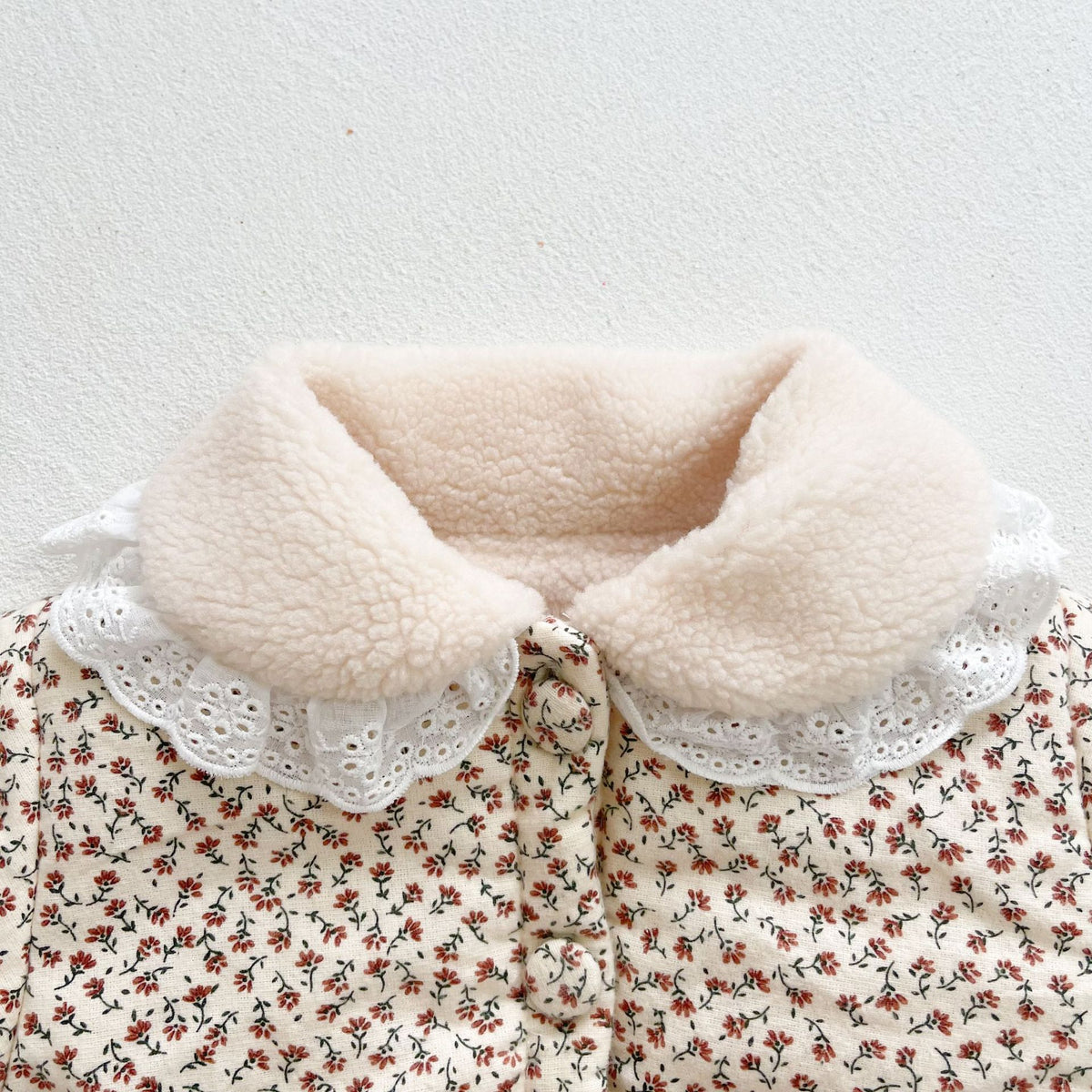 Close-up of the white eyelet lace ruffle collar