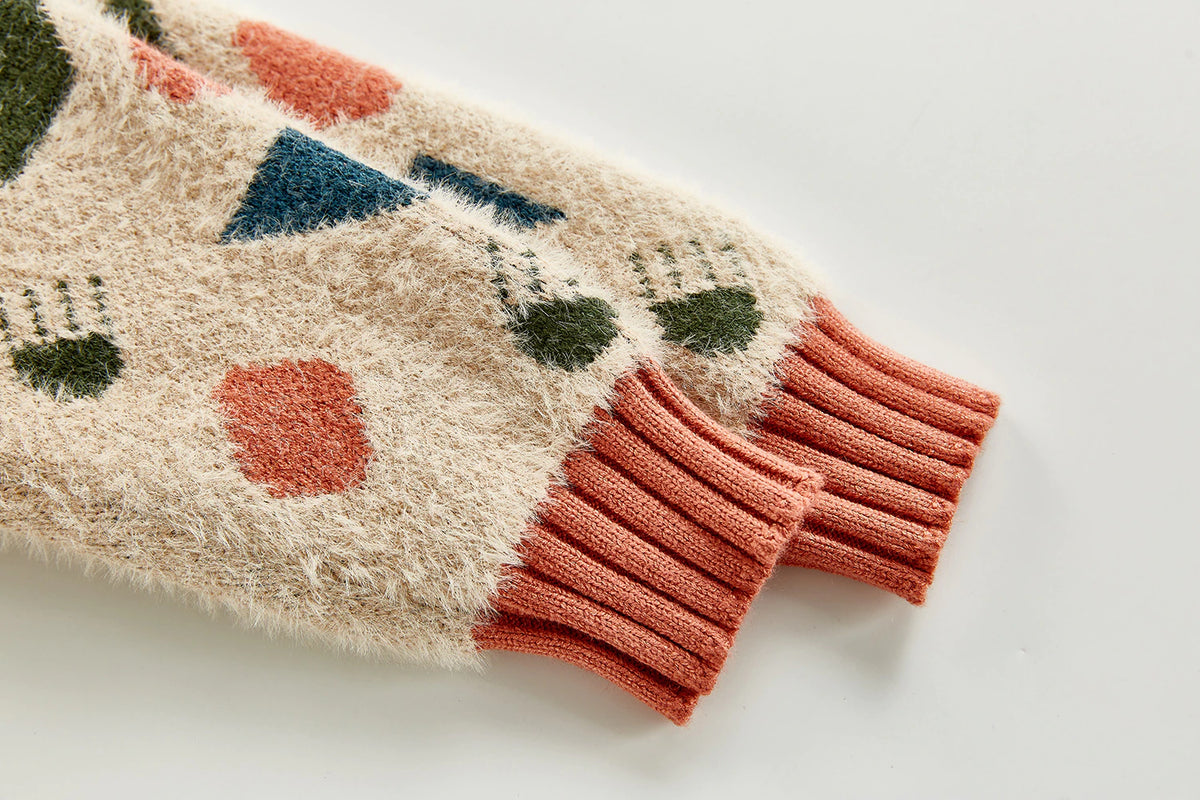 Close-up of orange cuff on geometric sweater