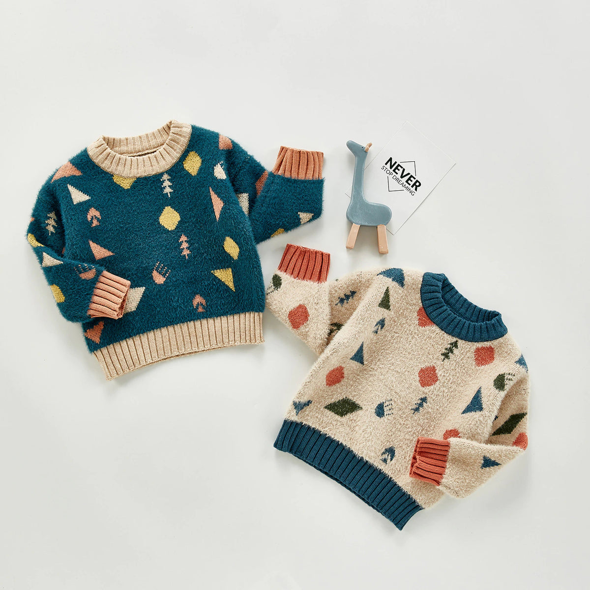 Geometric knit sweaters styled with toy