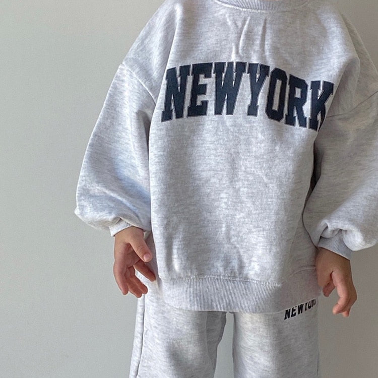 Close-up of NEW YORK lettering on gray sweatshirt