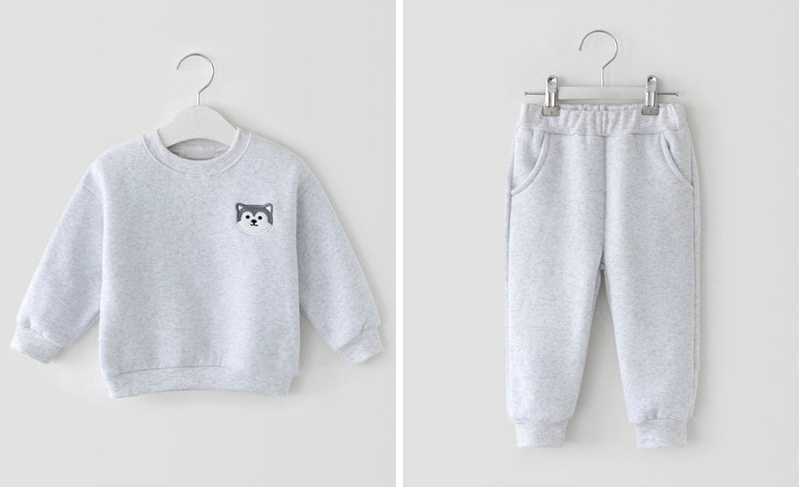 Grey sweatshirt and joggers on hangers