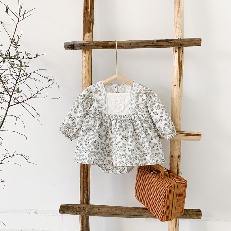 Grey floral retro dress on a ladder