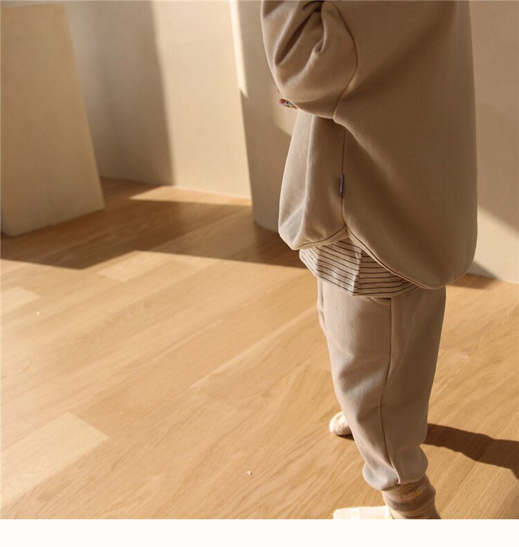Close-up of child in brown joggers