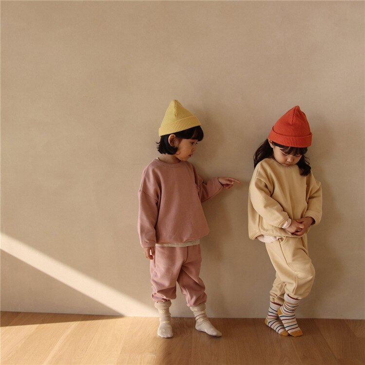 Kids in pink and yellow sweatshirt sets