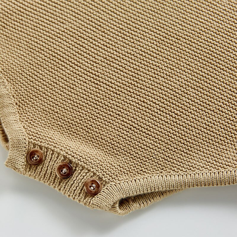 Close-up of snap buttons on knit bodysuit