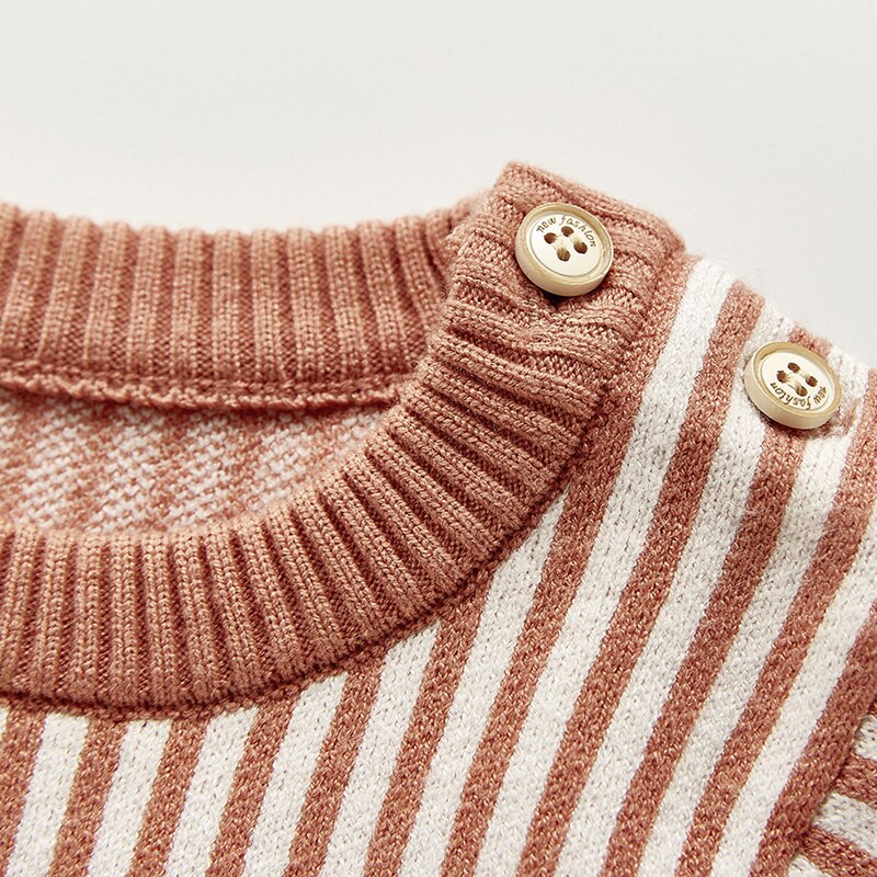 Close-up of shoulder buttons on rust knit jumpsuit