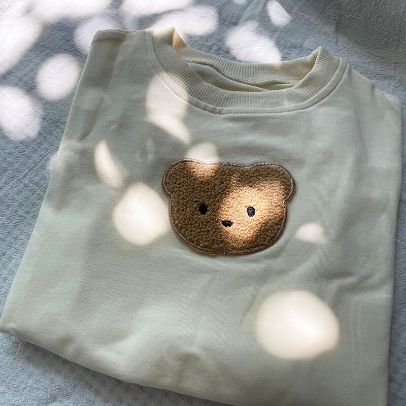 Close-up of mint bear sweatshirt