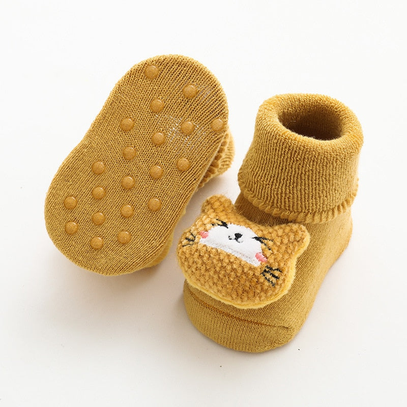Close-up of grip dots on yellow baby sock sole