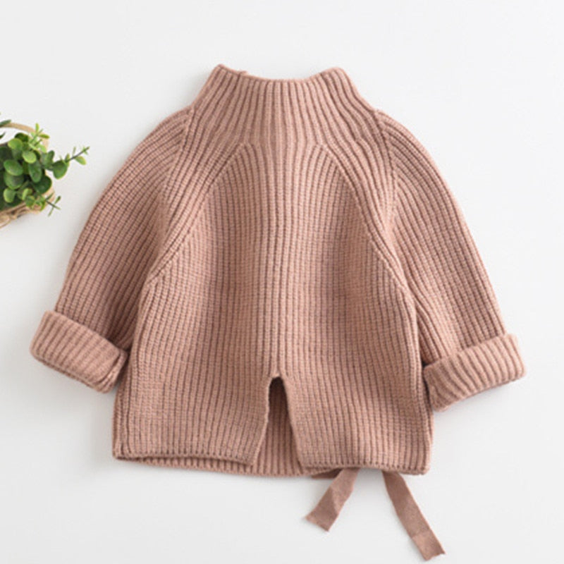 Pink chunky knit turtleneck with bow ties