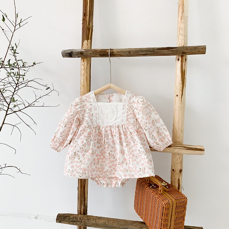 Pink floral retro dress on a ladder