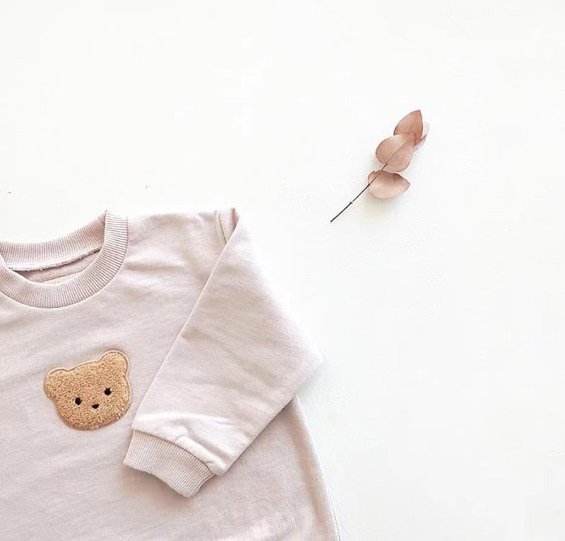 Light pink teddy bear sweatshirt close-up