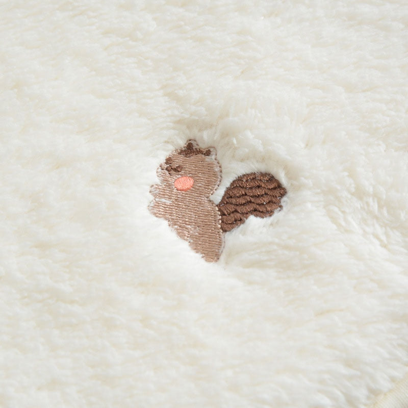 Close-up of squirrel embroidery on plush fabric