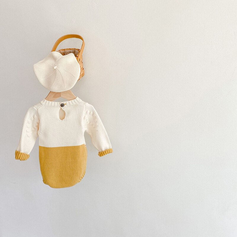 Sunflower knit bodysuit with hat on a hanger
