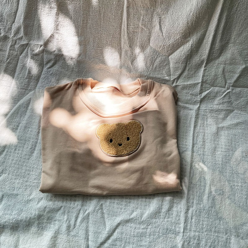 Folded taupe bear patch sweatshirt
