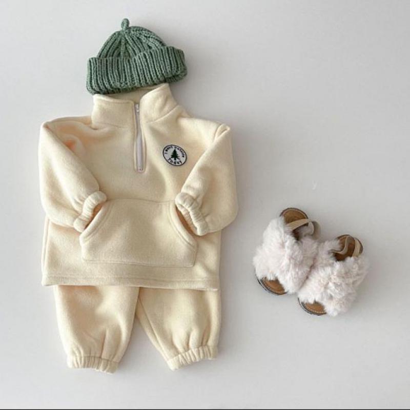Beige fleece toddler set with green beanie and sheepskin boots