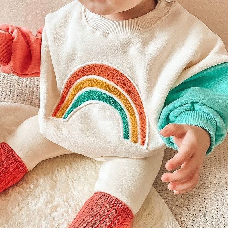 Toddler wearing rainbow colour block sweatshirt