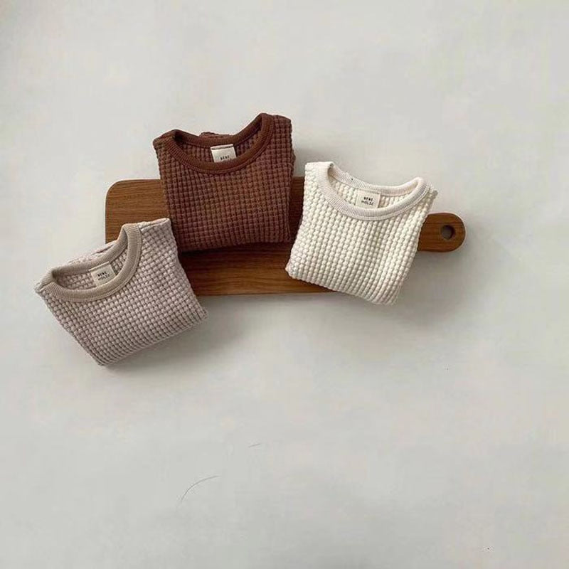 Waffle sweatshirts on a wooden board