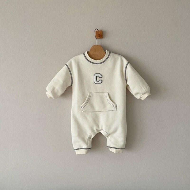 White C letter jumpsuit on a hanger