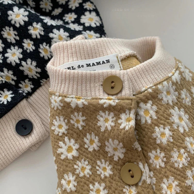 Close-up of buttons on yellow daisy cardigan