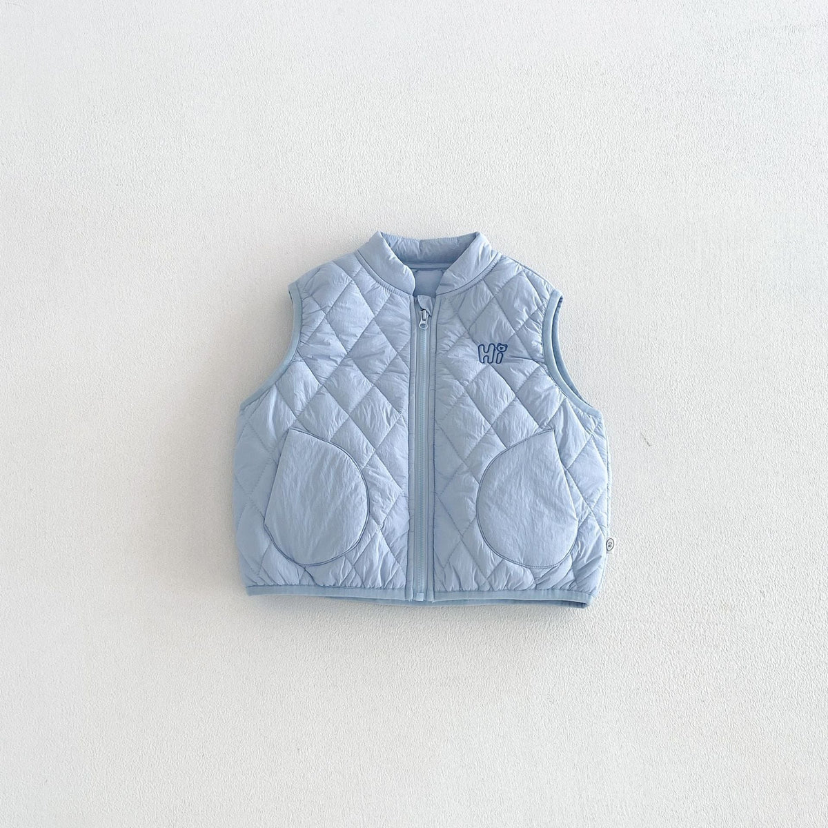 Sky blue quilted puffer vest, front view