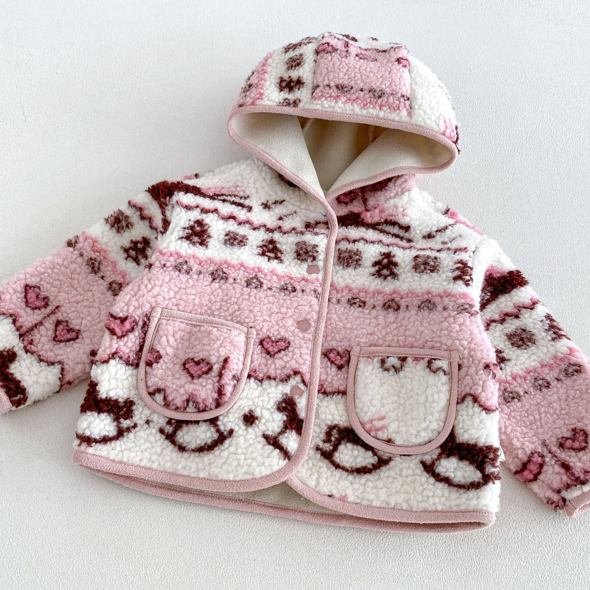 Close-up of the rose jacket's hood, piping and patch pockets