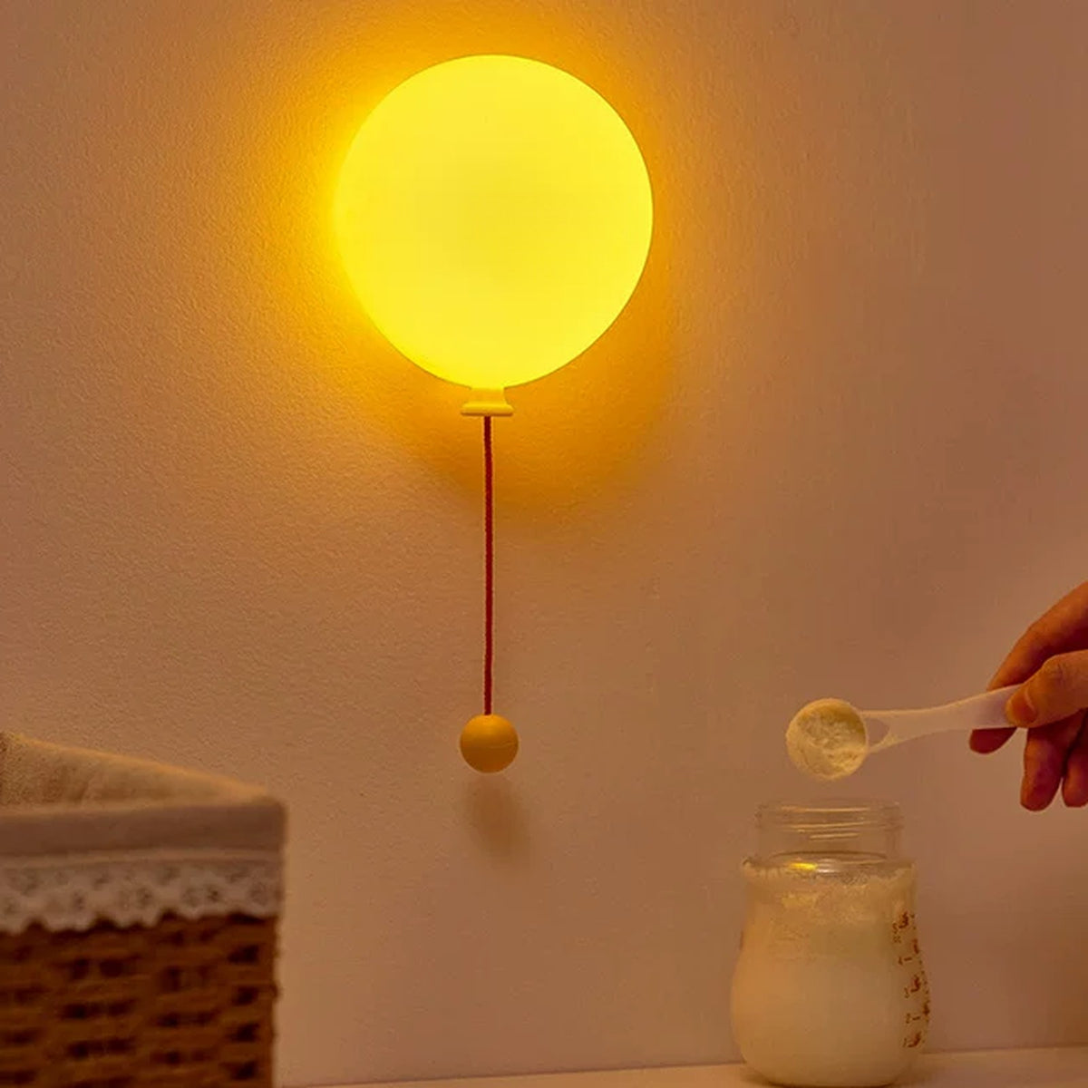 Balloon night light on the wall during a night-time bottle feed