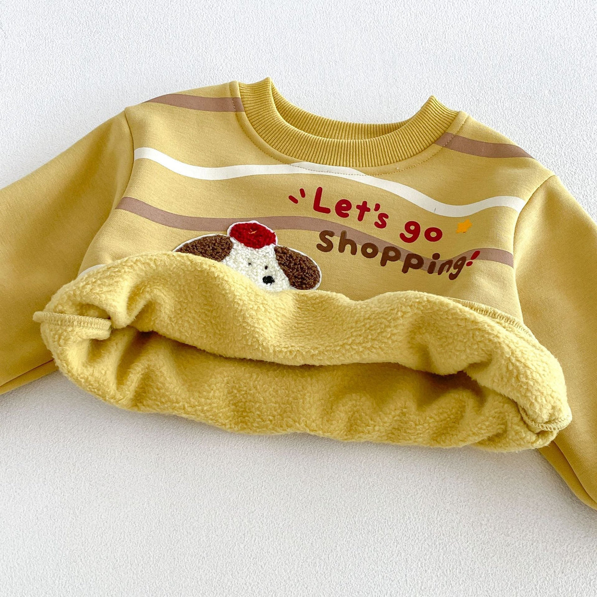 Soft fleece lining inside the mustard kids sweatshirt
