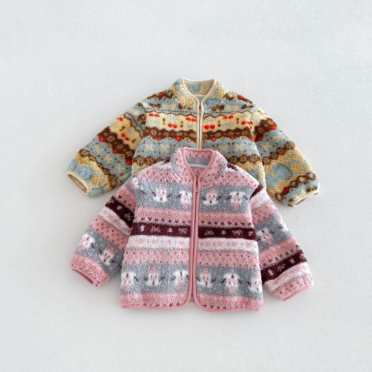 Rose and butter yellow Nordic folk fleece zip jackets for toddlers, flat lay
