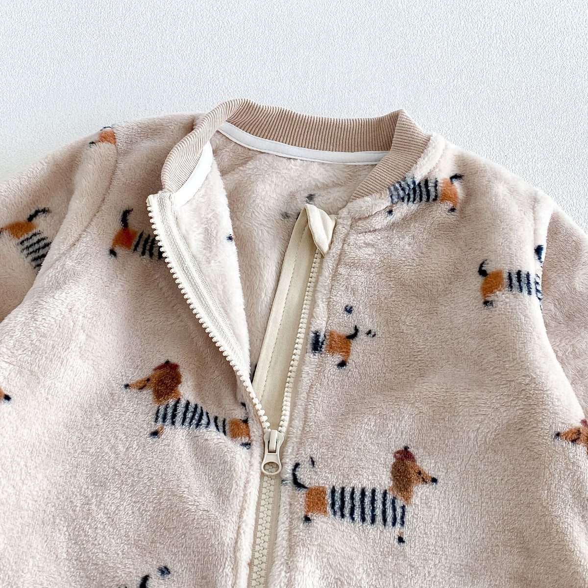 Open zip on the dachshund fleece romper showing the soft lining