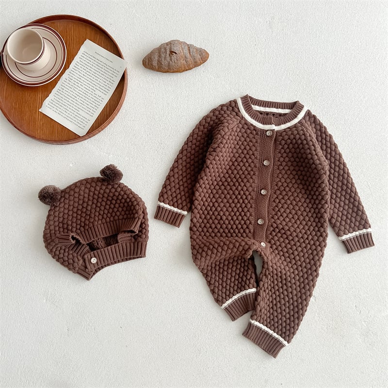 Brown popcorn knit baby romper with bear-ear hat, flat lay