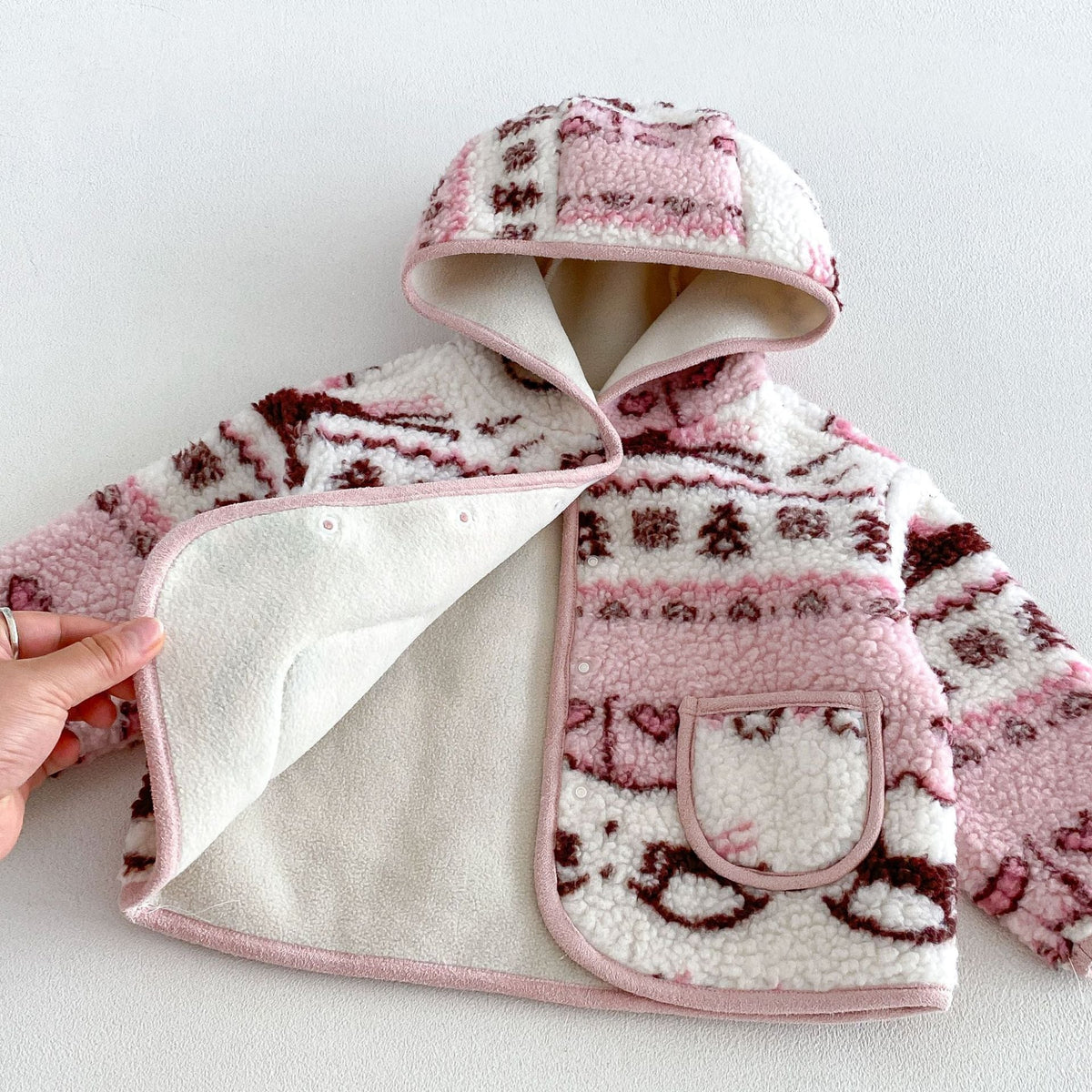 Rose sherpa jacket opened to show the soft fleece lining and snap front
