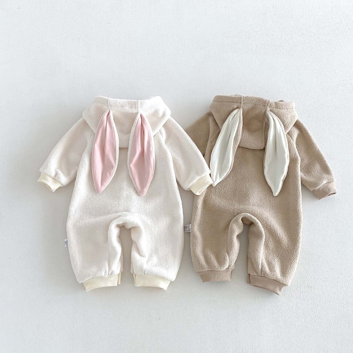 Back view of ivory and latte rompers with bunny ears on the hood