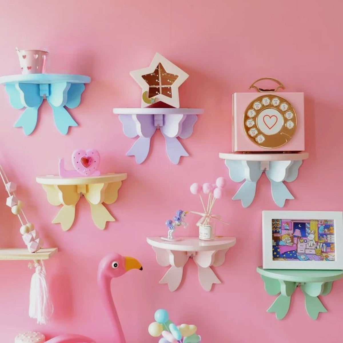 Pastel bow wall shelves in blue, lavender, butter, white and mint on a pink wall