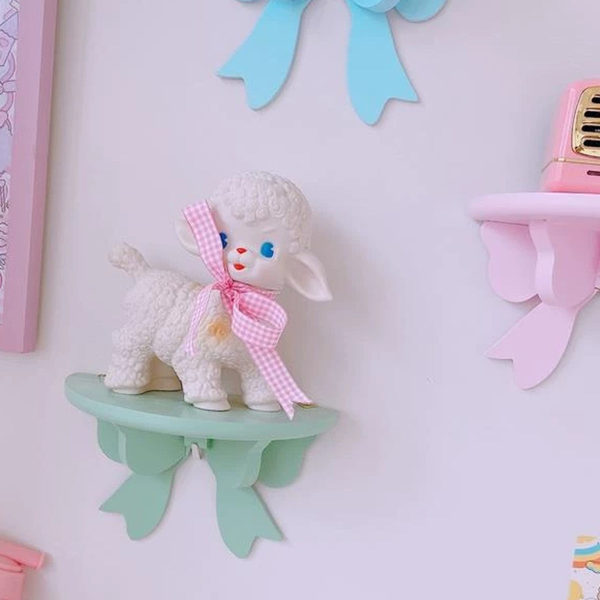 Mint bow shelf holding a vintage lamb figurine