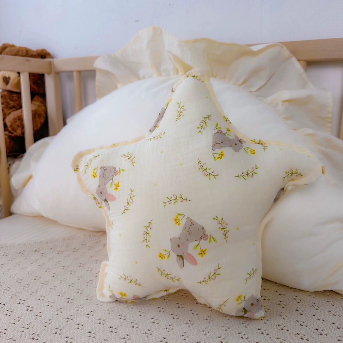 Bunny Meadow star cushion with grey bunnies and flowers