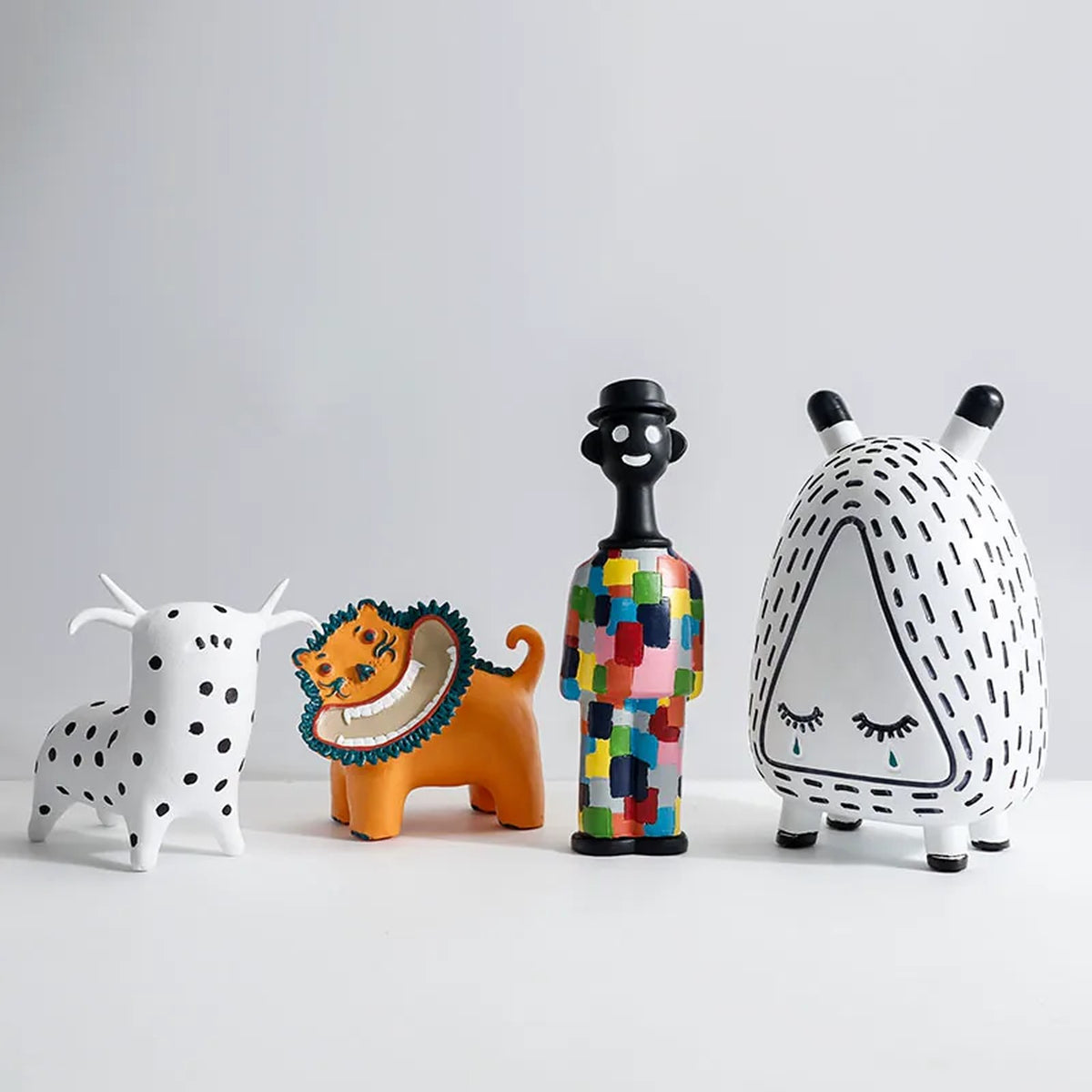 Spotty calf, lion, patchwork man and sleepy monster figurines together