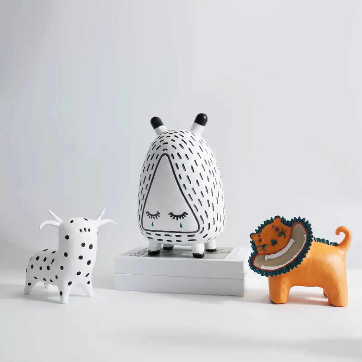 Character figurines styled on a shelf with books