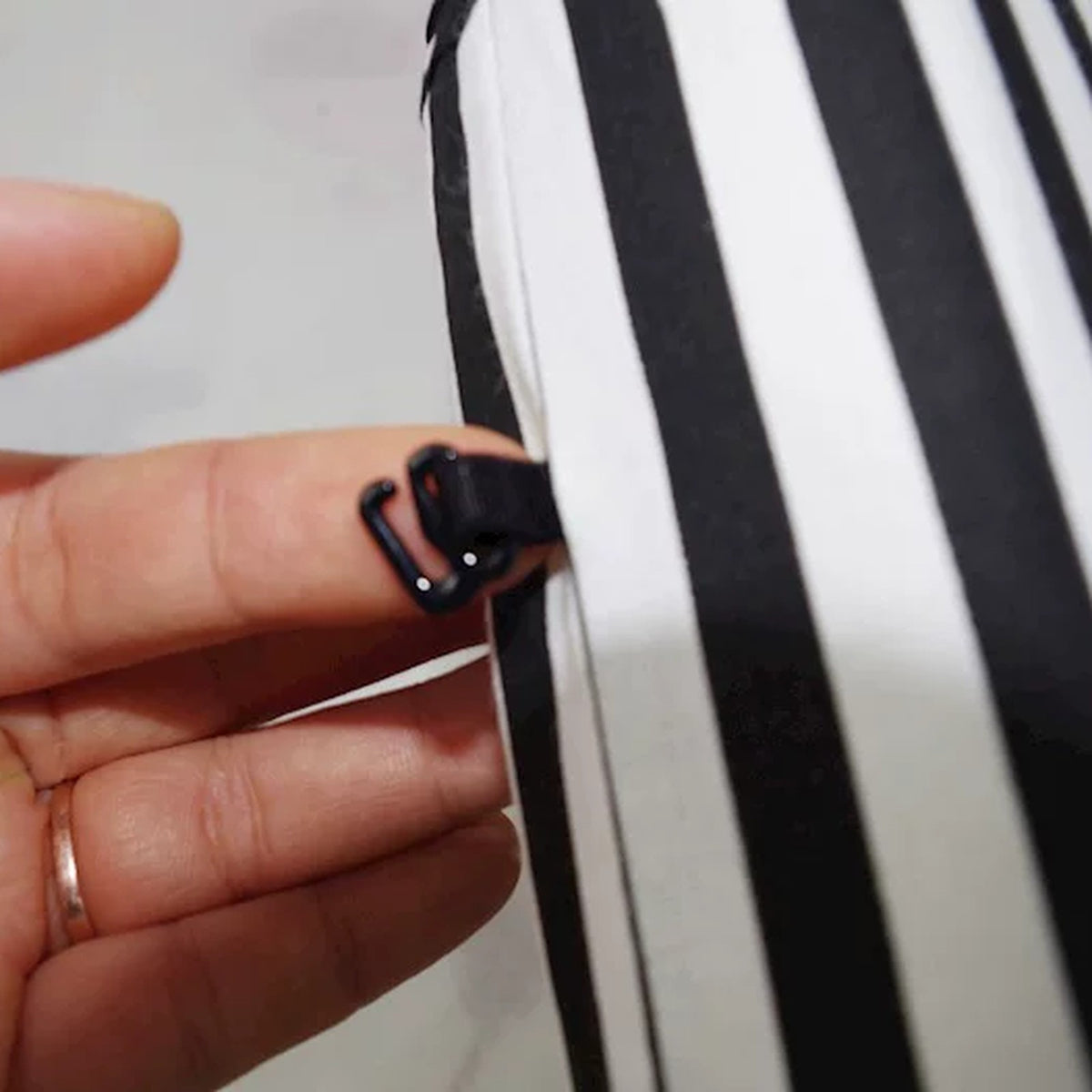 Close-up of the tie fastening on the back of a striped house cushion