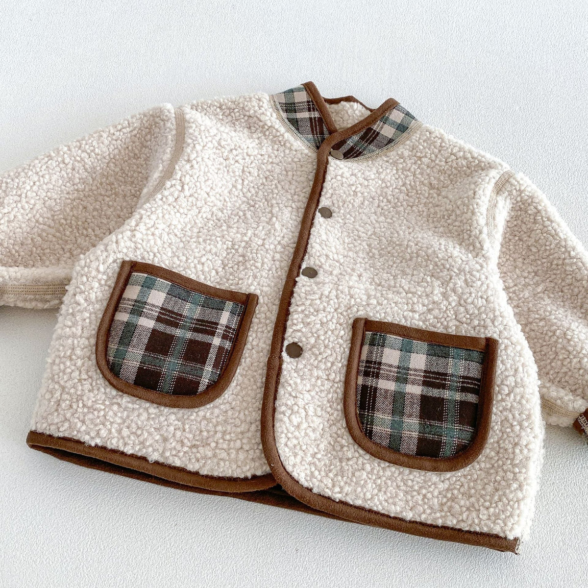 Sherpa side detail with plaid patch pockets and contrast piping