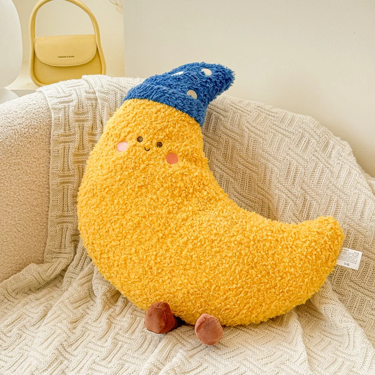 Yellow sleepy moon plush cushion with a blue night cap